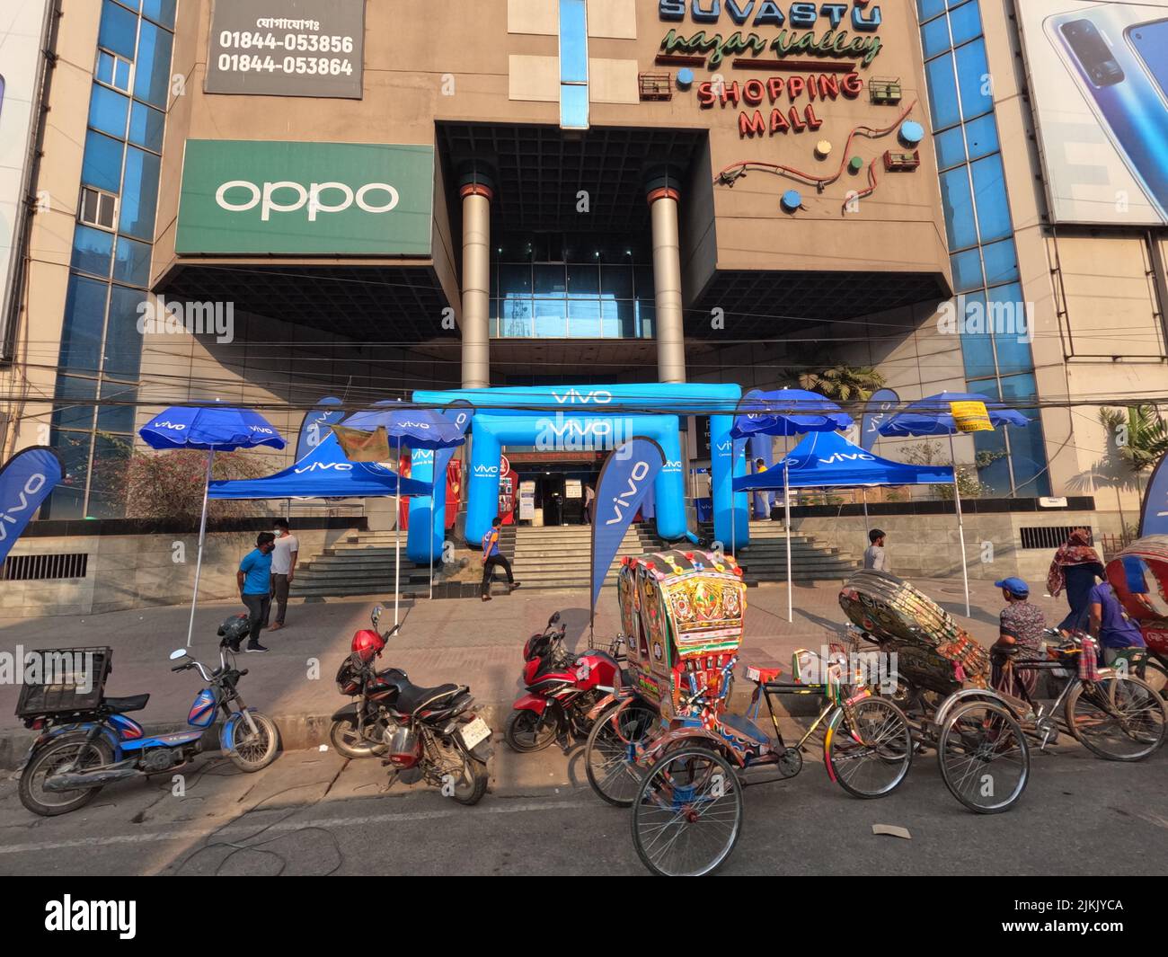 The commercial building facade with bicycles along the street in Dhaka