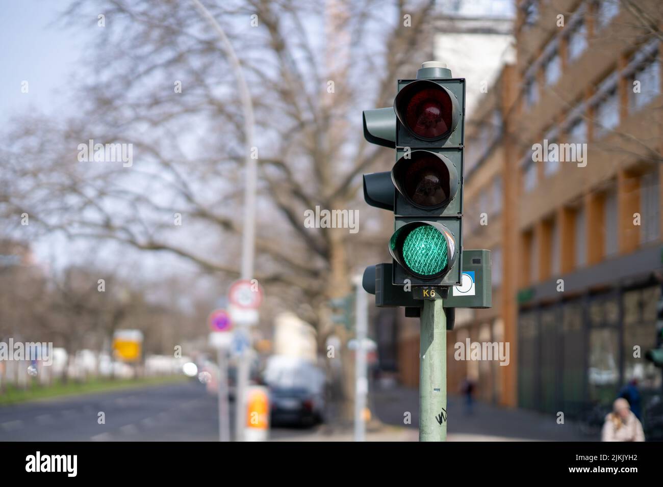 A photo of traffic lights in a city with the green lamp on Stock Photo