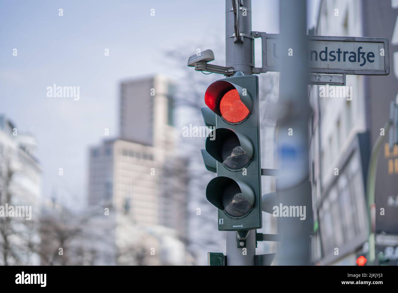 A photo of traffic lights in a city with the red lamp on Stock Photo