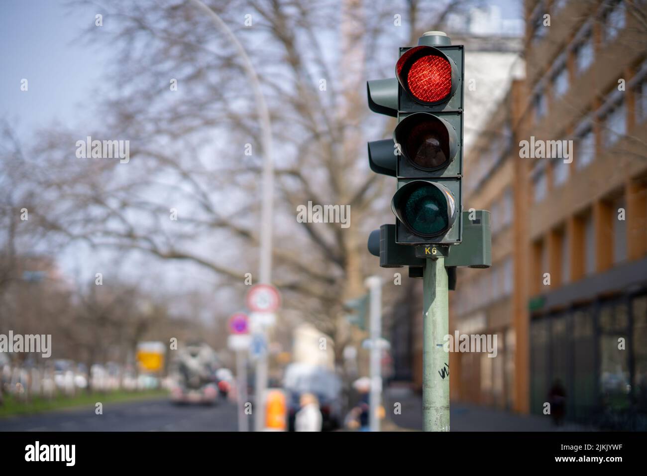 A photo of traffic lights in a city with the red lamp on Stock Photo