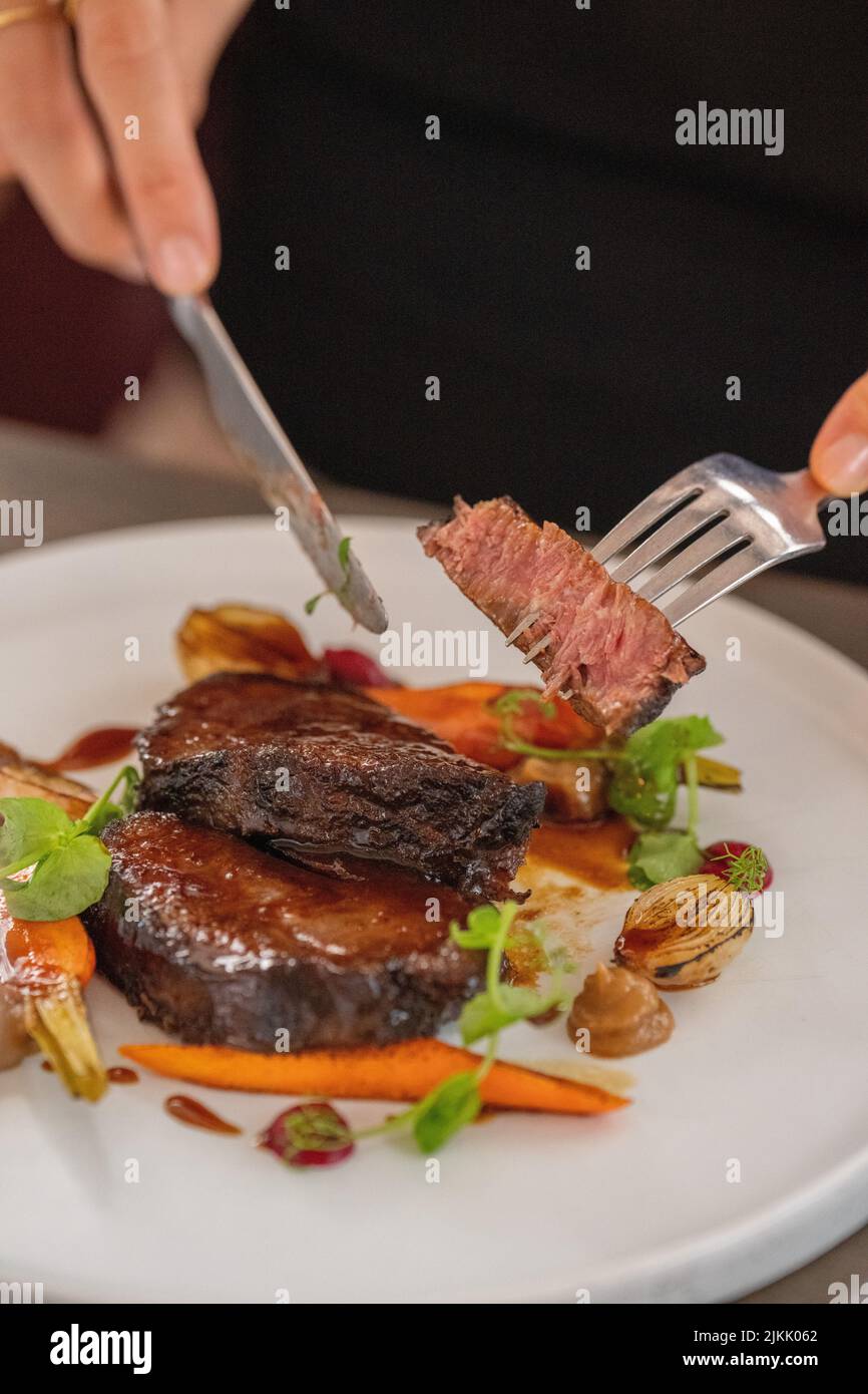A vertical closeup of a slowcooked beef cheek bourguignon served with