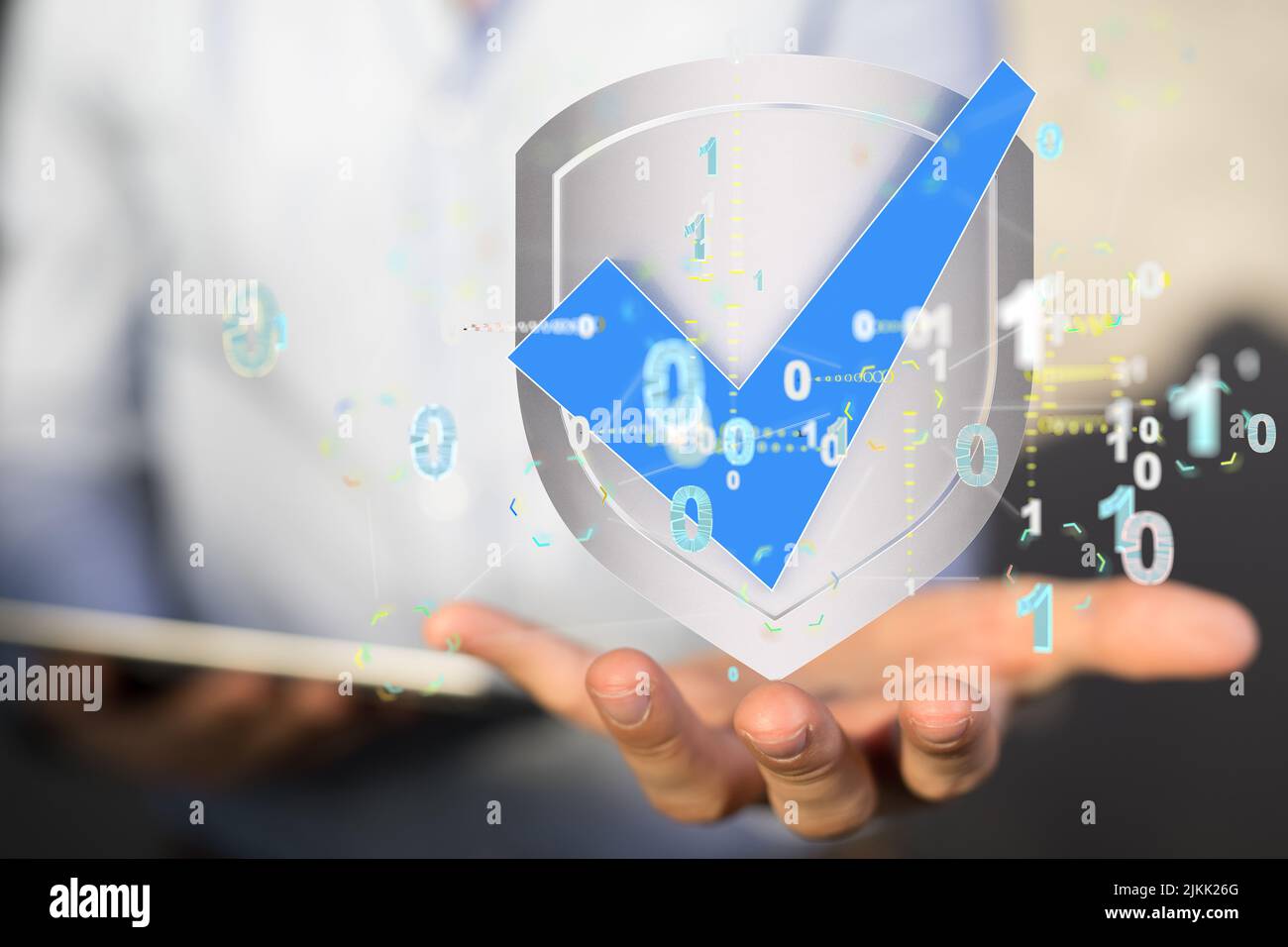 A person holding a security icon in a silver shield on his palm Stock Photo