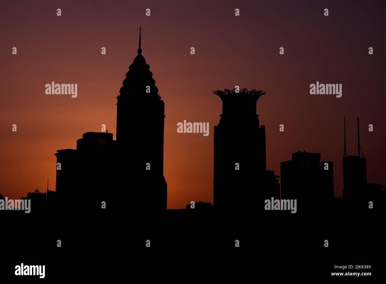 A silhouette of buildings and towers with sunset Stock Photo