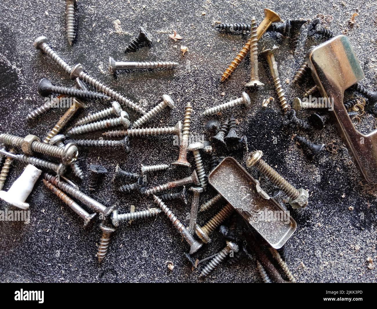 A closeup of rusty screws on the ground Stock Photo