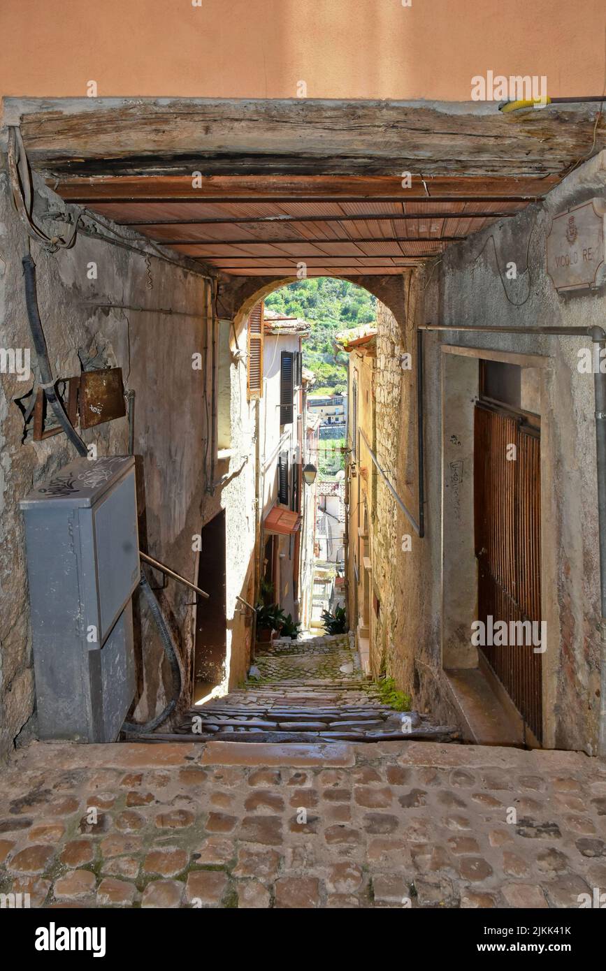 A vertical shot of a narrow cobblestone corridor path between old ...