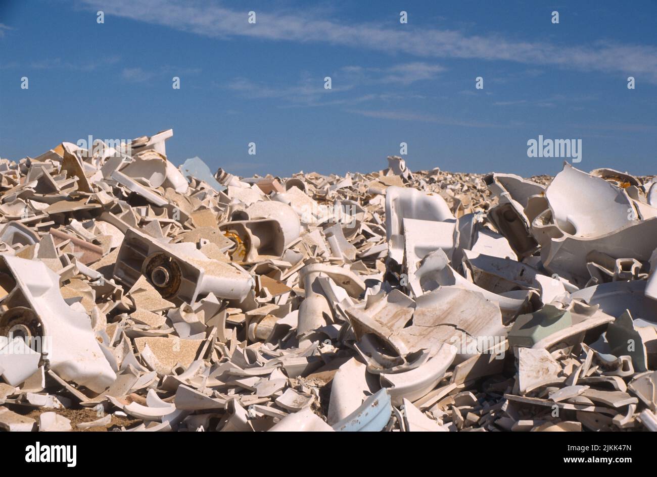 Broken toilets and other bathroom fixtures intended for recycling into paving asphalt at the Miramar landfill in San Diego, California Stock Photo