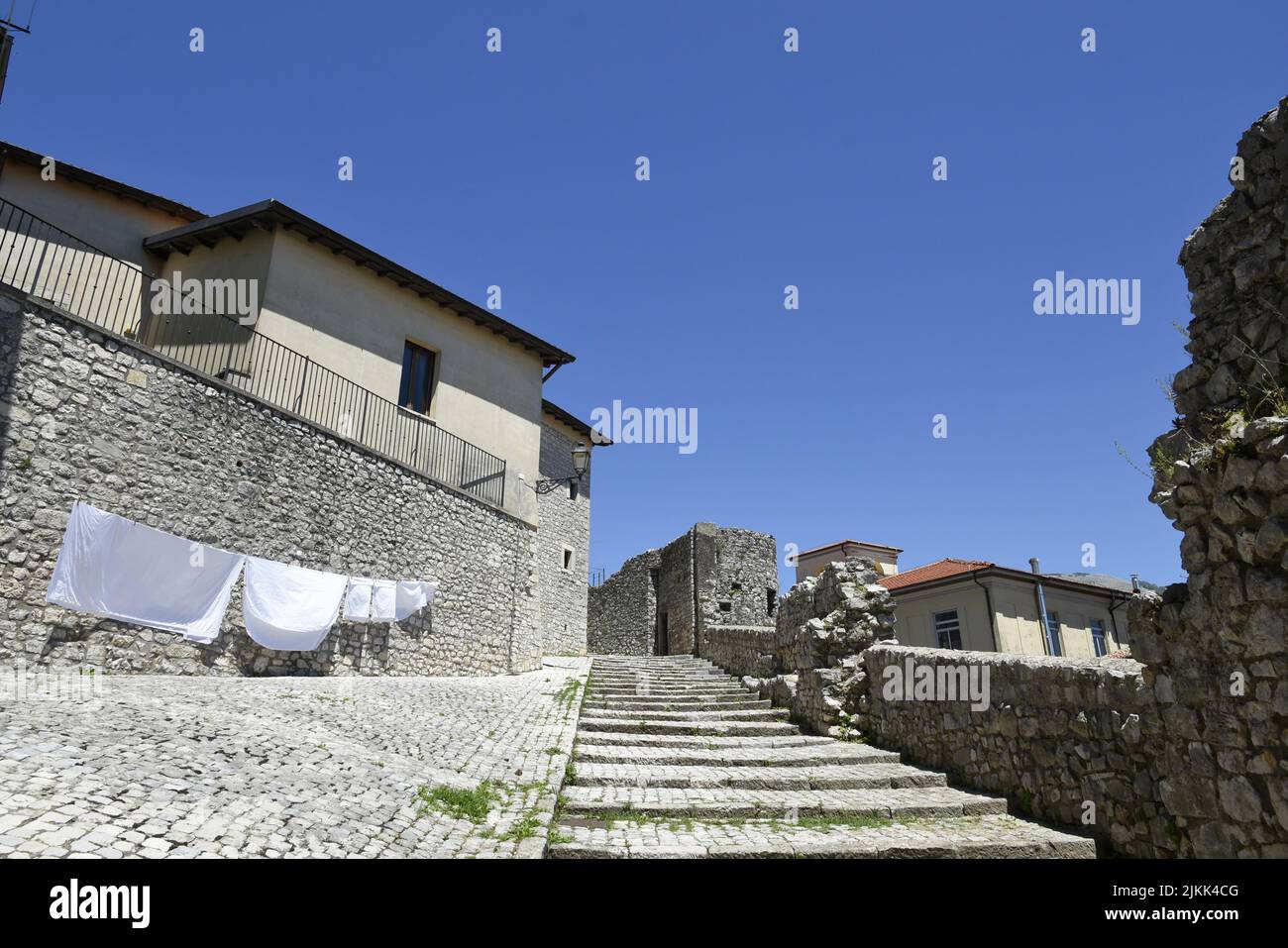 A street between old medieval stone buildings in Italy. Stock Photo