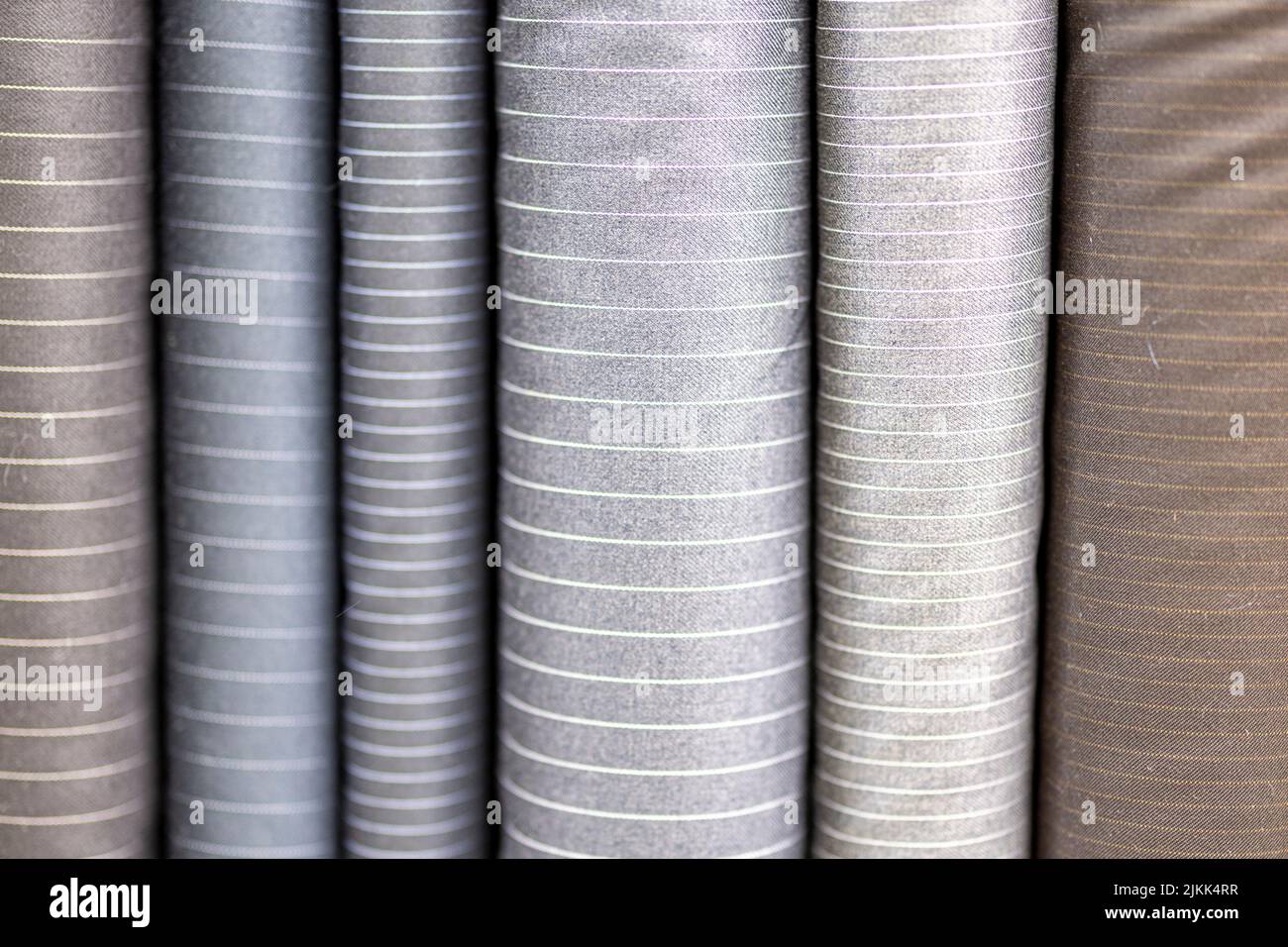 The bolts of fabric for making suits by a tailor pin stripes bespoke Stock Photo