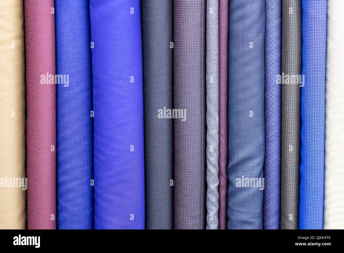 The blue, brown and gray bolts for making suits of fabric for making