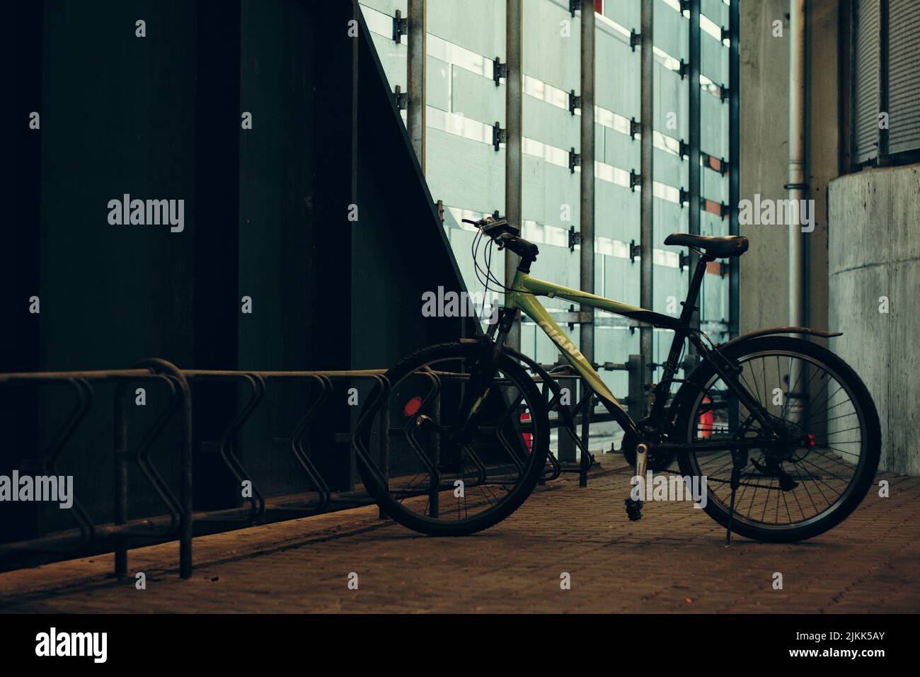 The yellow bicycle parked in the street. Stock Photo