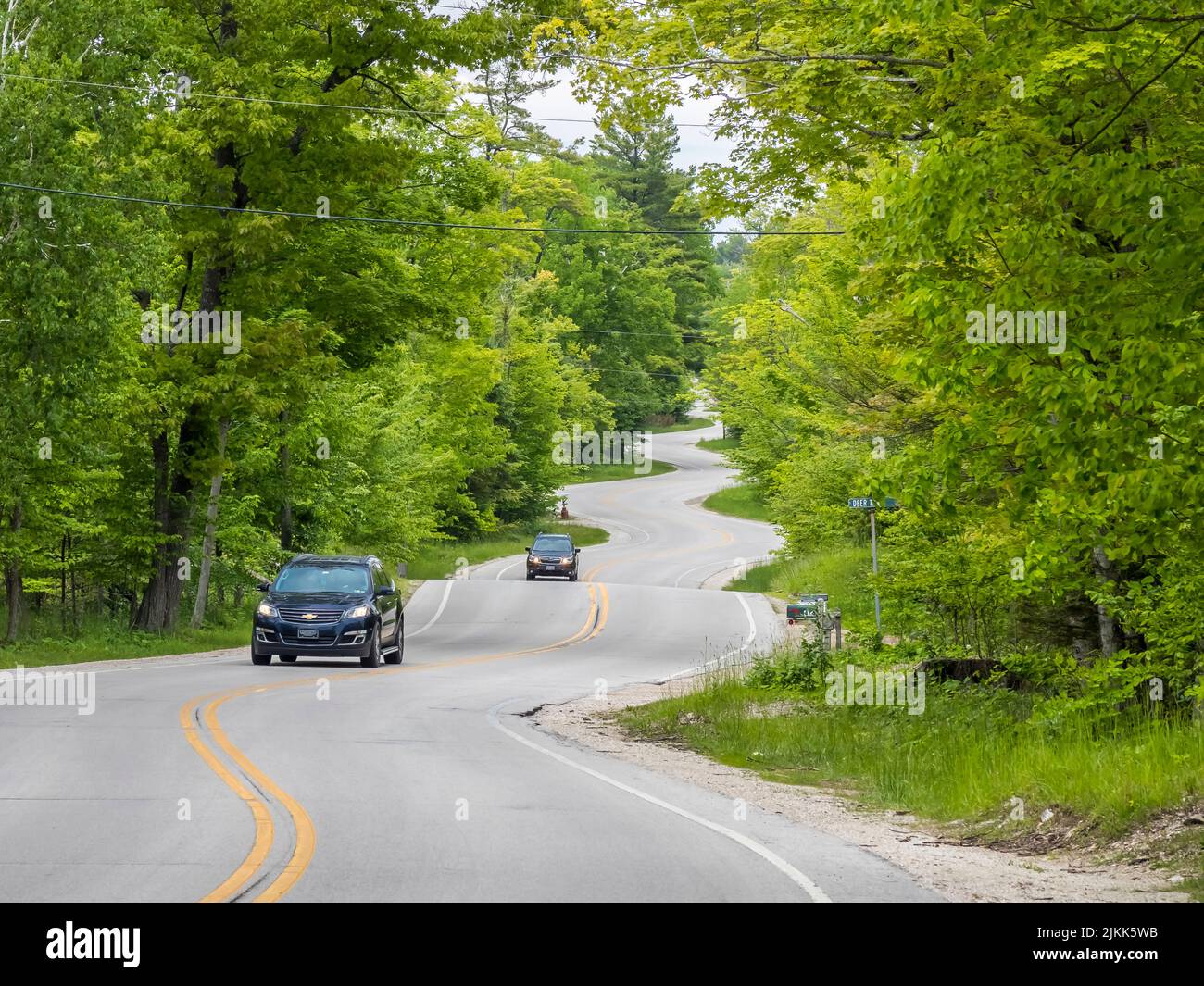Cars on curving Route 42 in Door County Wisconsin USA Stock Photo