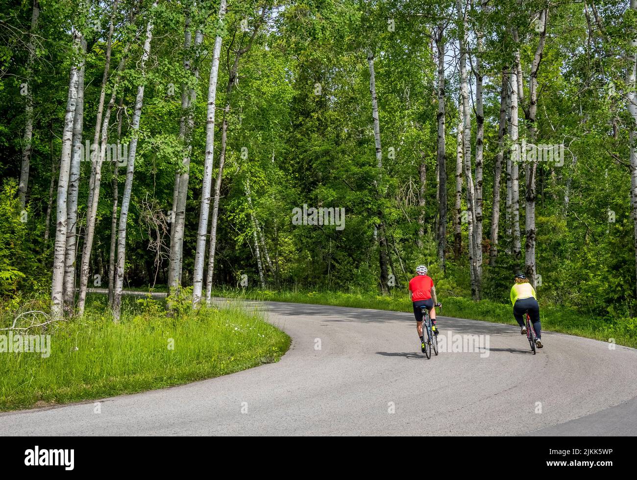 Couple riding bikes in Peninsula State Park in Door County Wisconsin USA Stock Photo