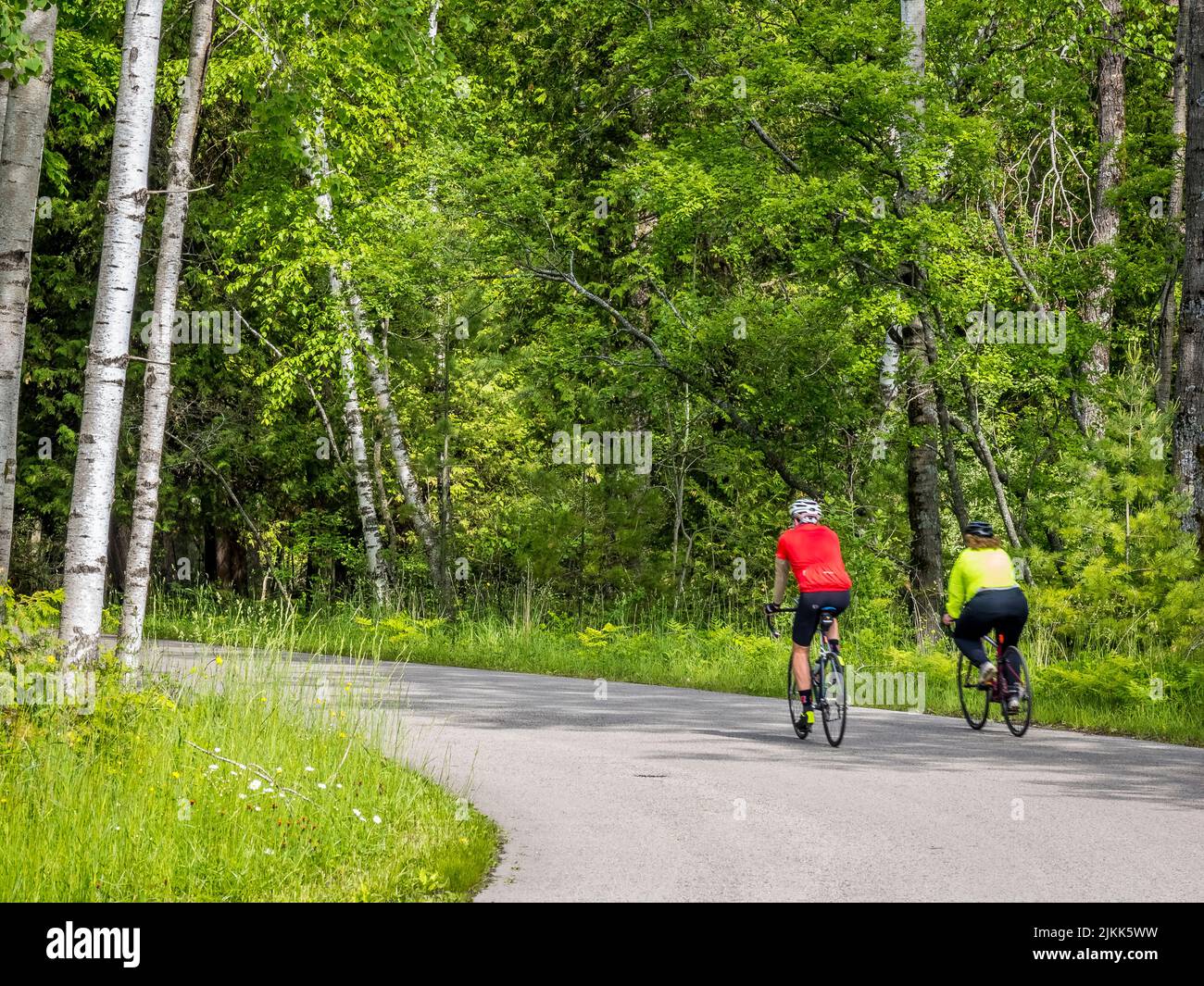 Couple riding bikes in Peninsula State Park in Door County Wisconsin USA Stock Photo