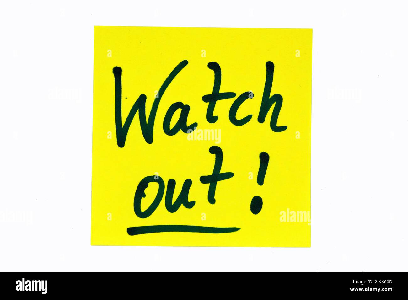 A black colored motivational quote saying 'Watch out!' on a yellow note Stock Photo