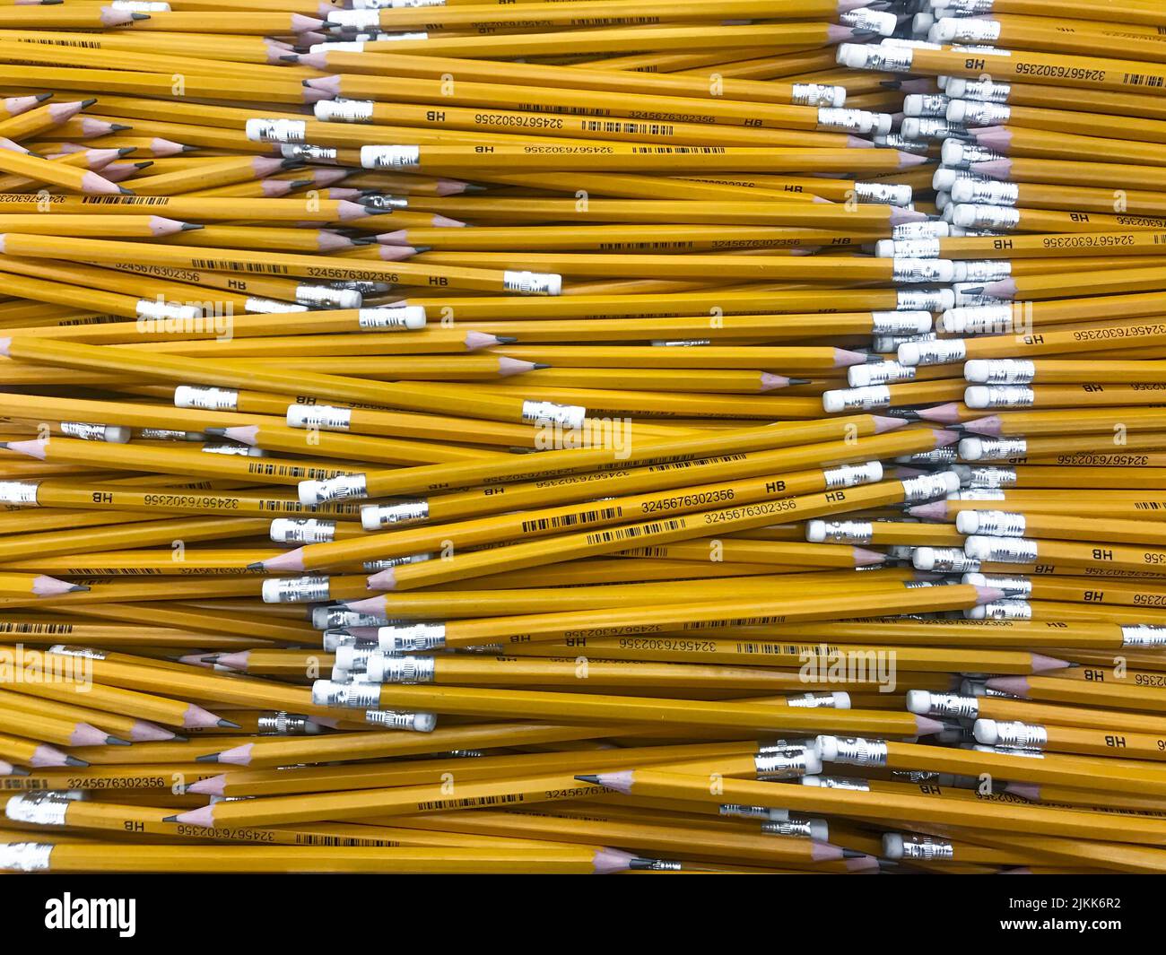 Moscow, Russia, August 2019: Close-up of many simple yellow wooden pencils with white erasers on the tips, one with a broken lead. Education concept, Stock Photo