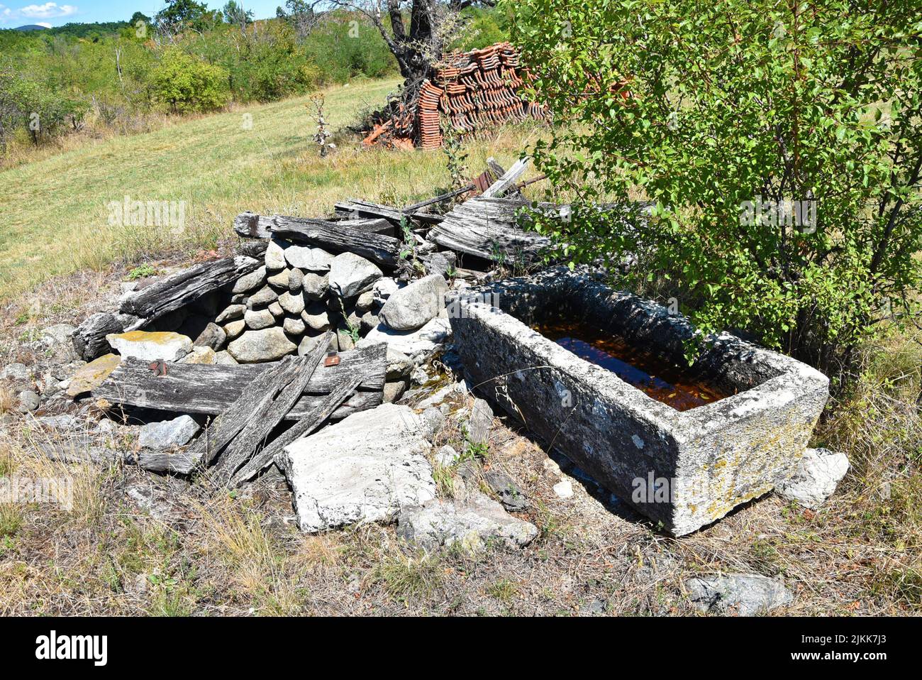 Old well and drinking trough for livestock on old farm Stock Photo Alamy