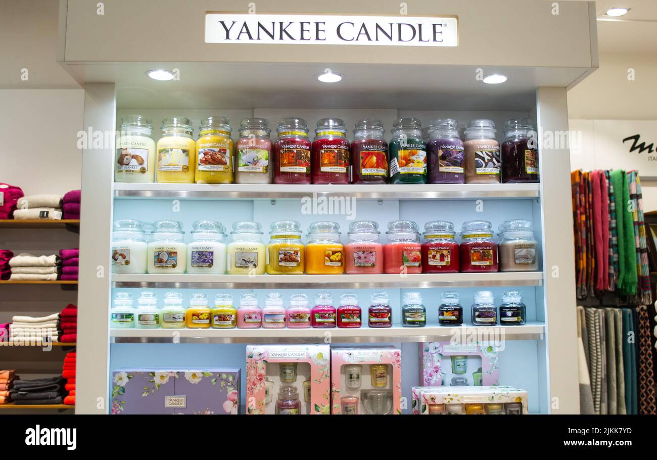 Moscow, Russia, November 2020: Corner of the Yankee candle brand in the megamall. Showcase with a variety of scented candles in glass jars. Stock Photo