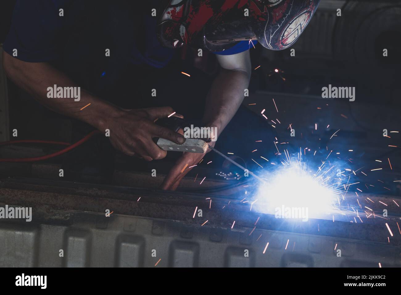 A welder welding automotive part in a car factory Stock Photo Alamy