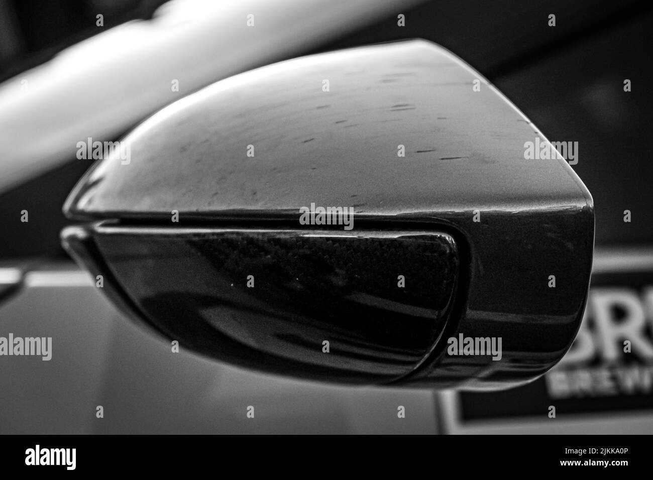 A grayscale closeup of the side mirror of a car Stock Photo