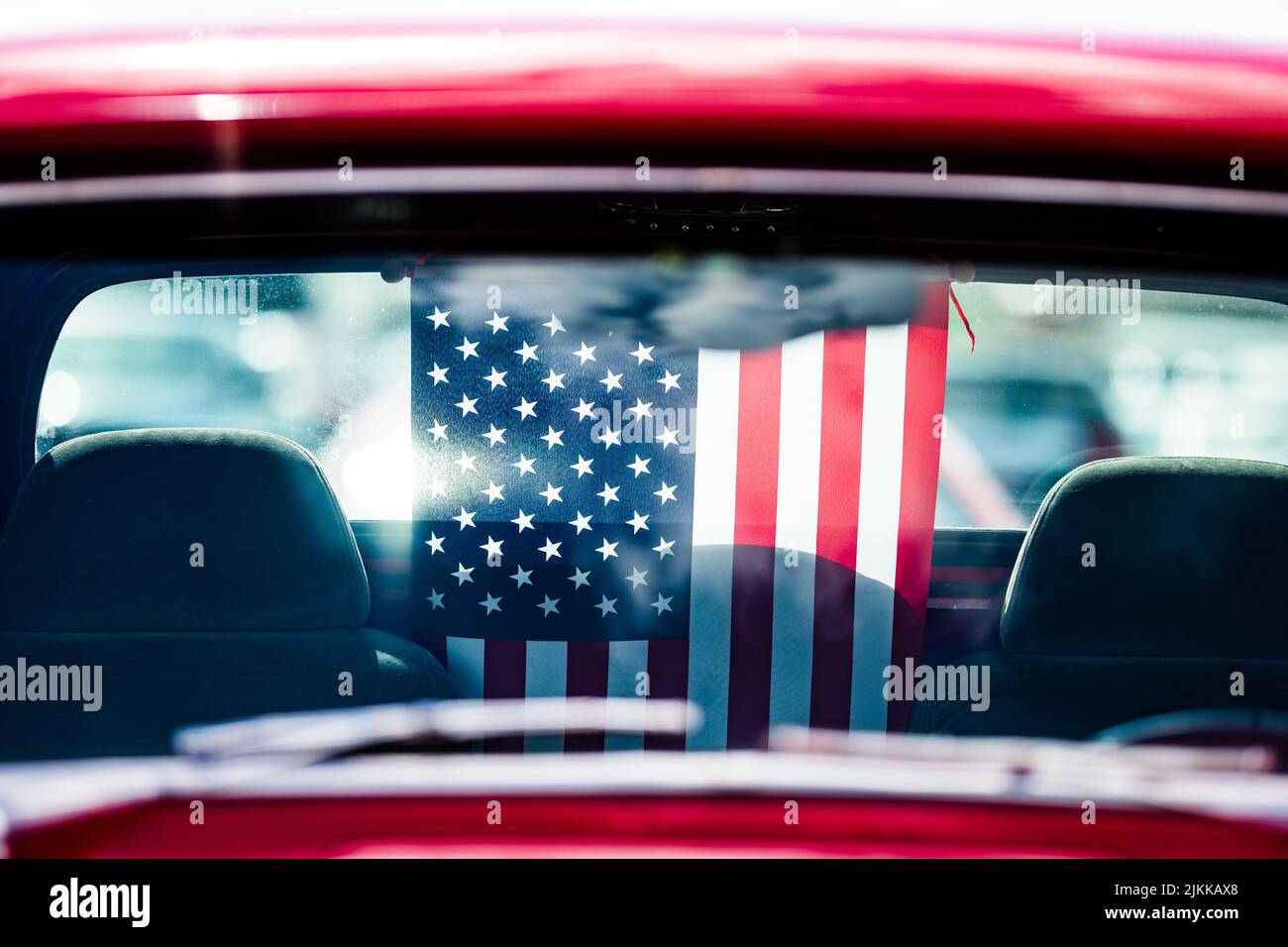The United States flag inside Red pickup antique truck nearside mirror Stock Photo