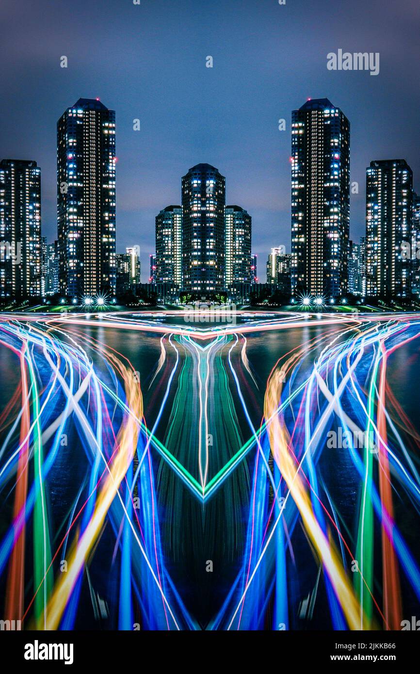 A vertical shot of cityscape with tall buildings in night with time-lapse colorful lights Stock Photo