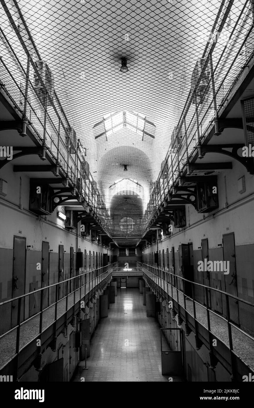 A vertical shot of a big hall looks like a jail with a big number of
