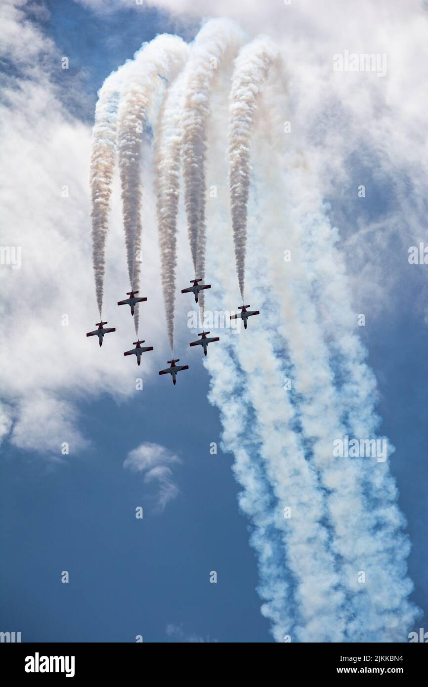 A vertical shot of the beautiful Spain Airforce Show with smoke traces on their back in a blue sky Stock Photo