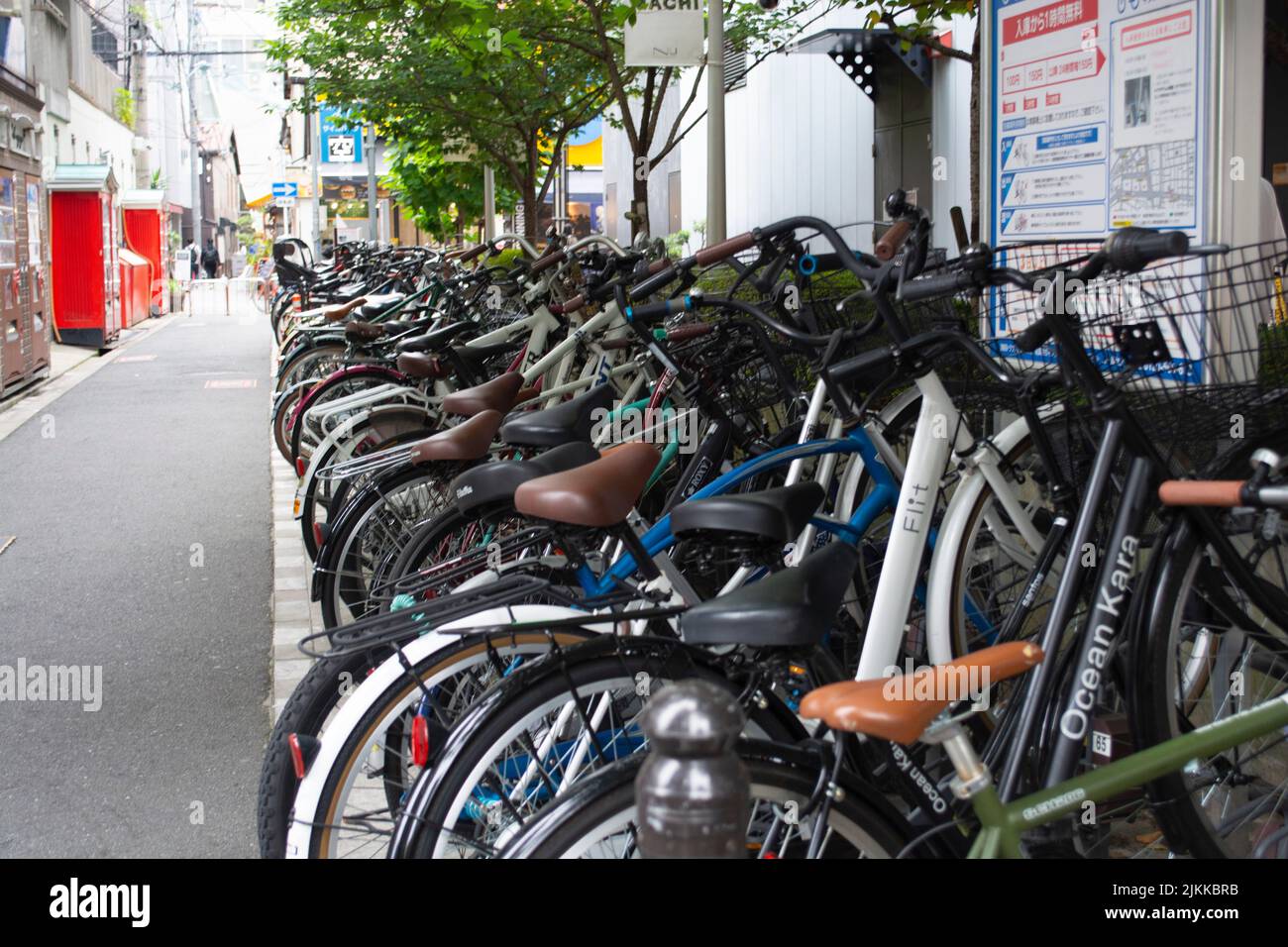 Bikes lined up in wrack on side street in Japan Stock Photo