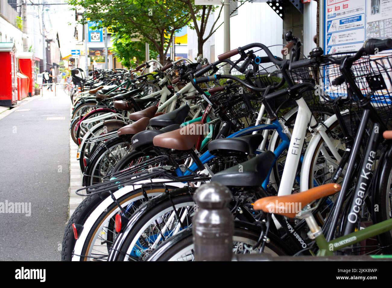Bikes lined up in wrack on side street in Japan Stock Photo