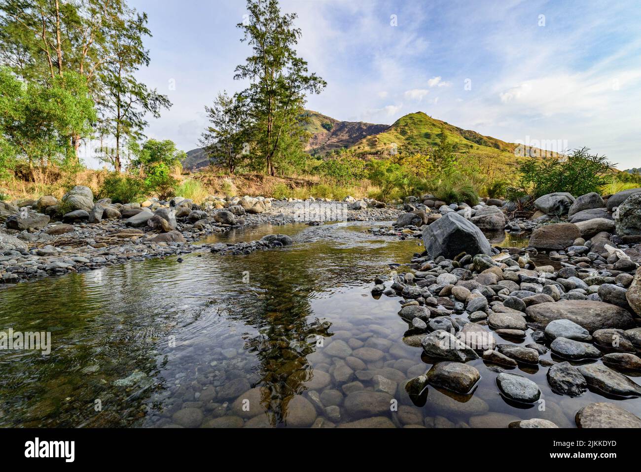 A scenic view of the river flowing through its rocky banks surrounded ...