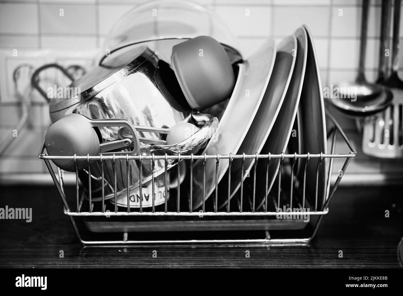 A grayscale of dishes in a metal basket Stock Photo