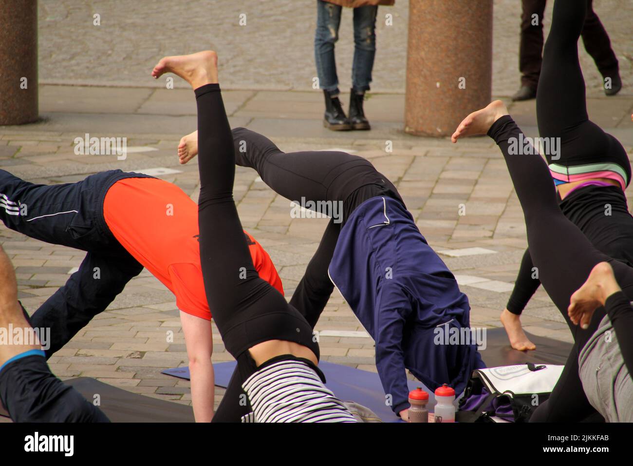 A people during a yoga class in the street in Lon, United Kingdom Stock Photo
