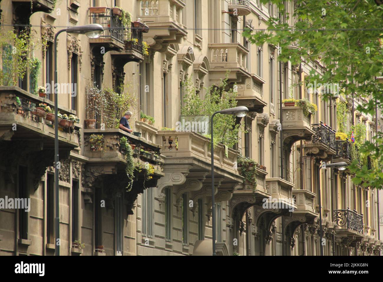 The facade of a beautiful, ornamental building with balconies in Milan Stock Photo
