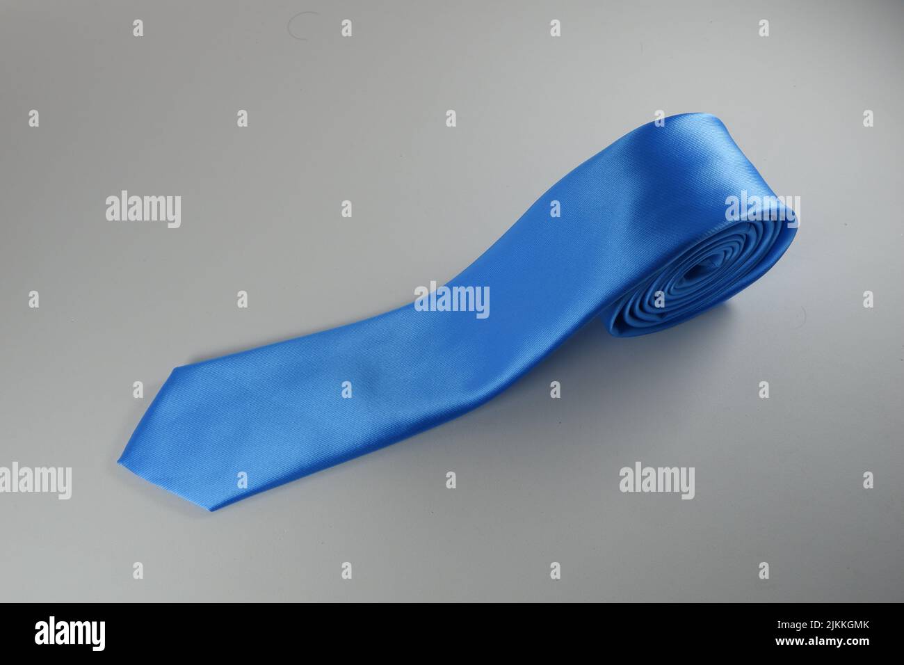 A closeup of blue polyester necktie on a white background Stock Photo