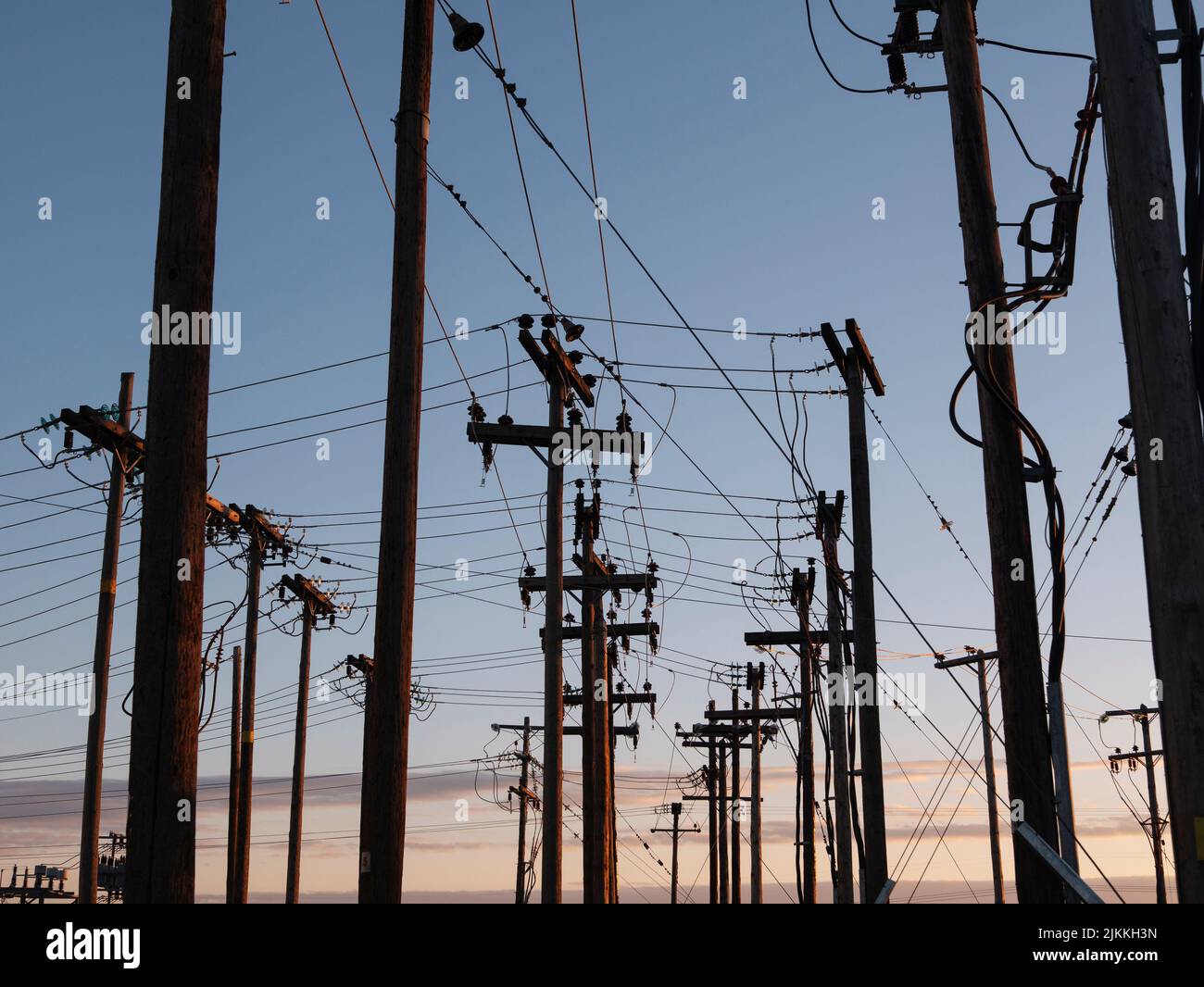 Transmission towers against a blue sunset sky Stock Photo - Alamy