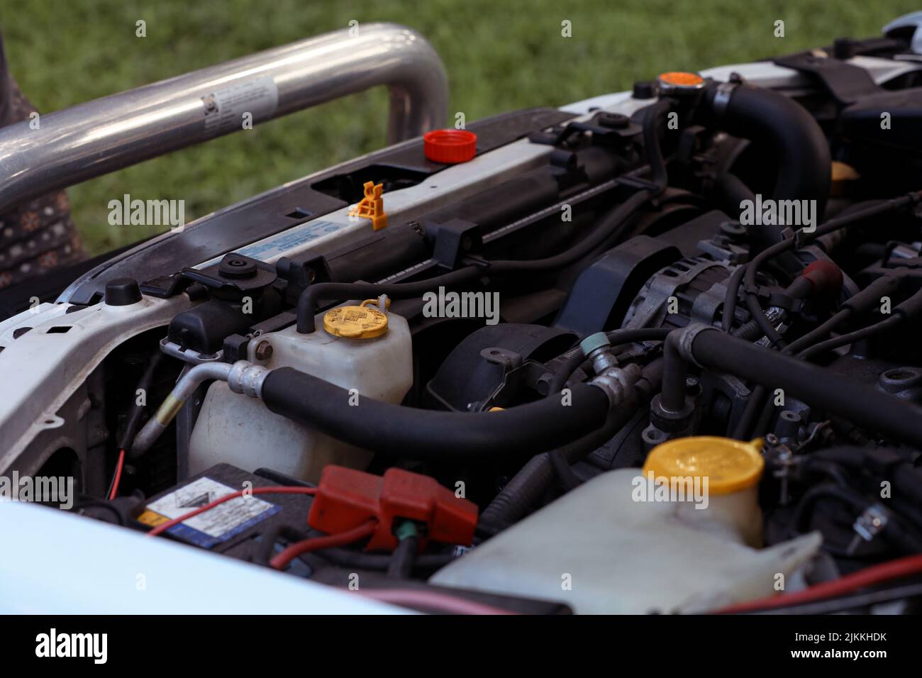 A closeup shot of oil bottles and an auto engine in a car hood Stock Photo Alamy