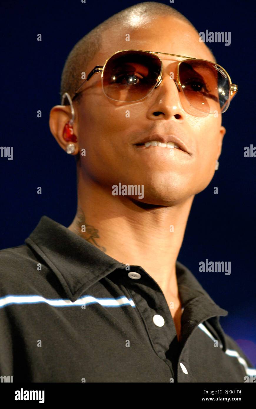 A vertical shot of Pharrell Williams performing live in Hollywood while wearing sunglasses Stock Photo