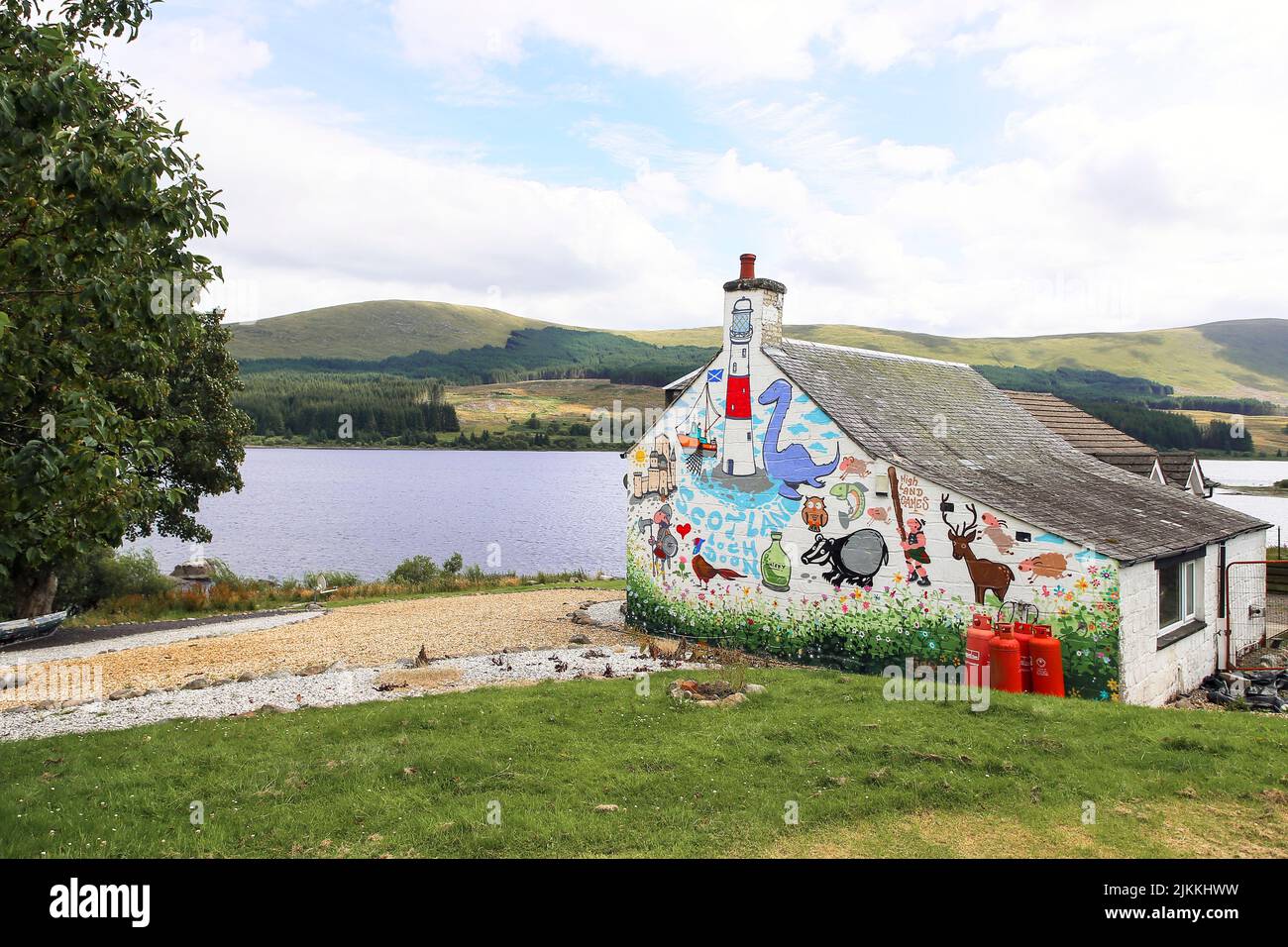 The decorated gable wall of Craigmalloch Lodge showing different aspects of Scotland, on the shores of Loch Doon, near Galloway Forrest,  Scotland Stock Photo