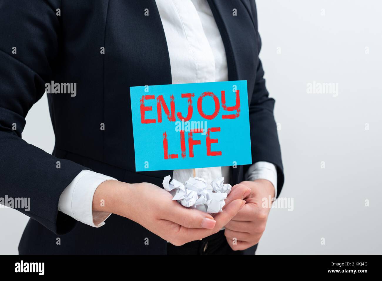 Hand writing sign Enjoy Life. Conceptual photo Any thing, place,food or person, that makes you relax and happy Businesswoman Holding Paper Wraps And Stock Photo