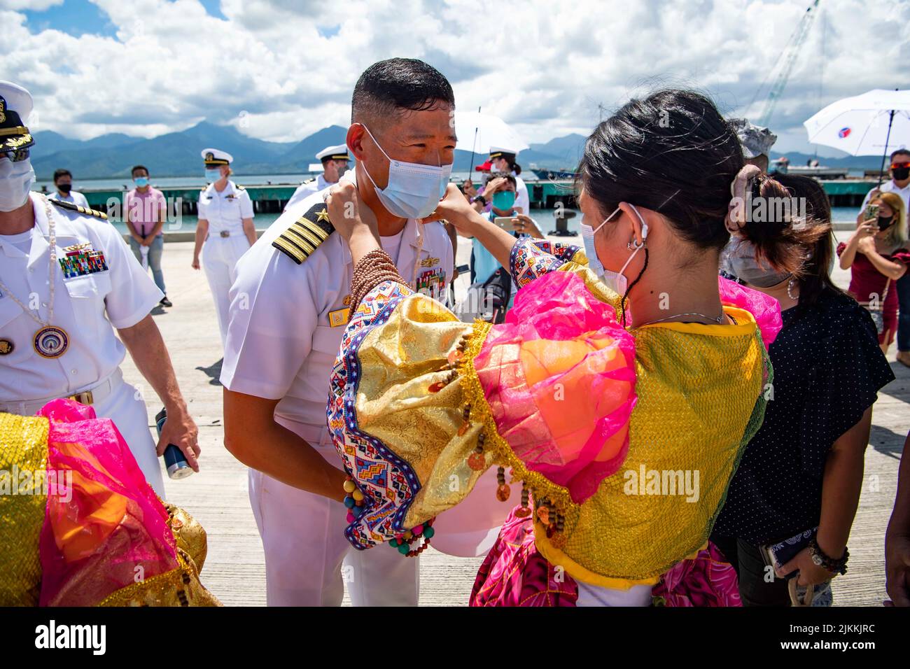Puerto Princesa, Philippines. 27 July, 2022. U.S. Navy Capt. Hank Kim, Pacific Partnership 2022 mission commander, receives a traditional necklace from a Filipina cultural dancer upon arrival aboard the USNS Mercy during the kickoff of the Pacific Partnership July 27, 2022 in Puerto Princesa, Philippines.  Credit: MC3 Michael Singley/Planetpix/Alamy Live News Stock Photo