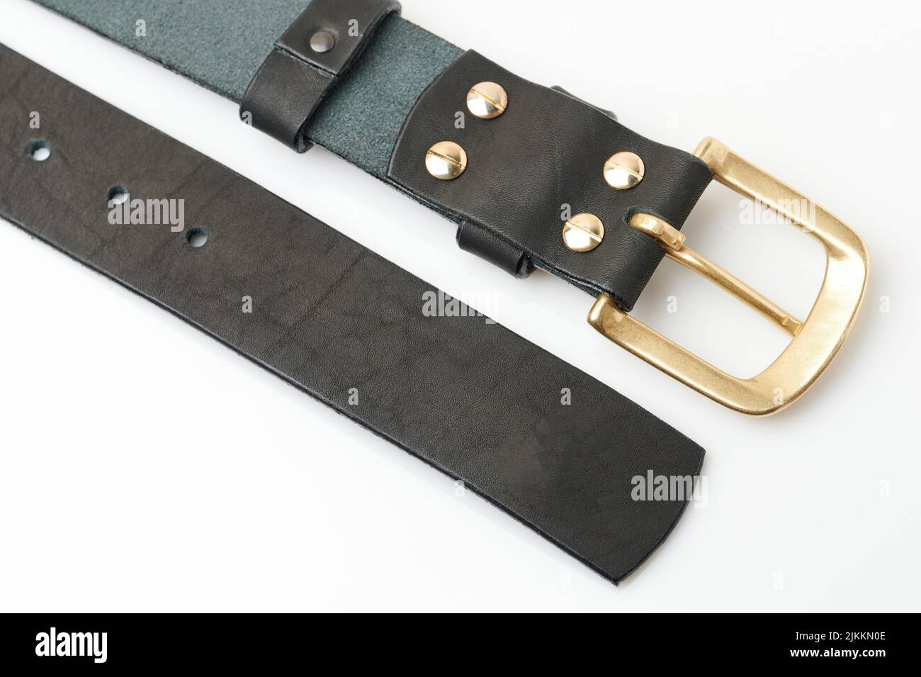 Brown leather belt with golden buckle isolated on studio background Stock Photo