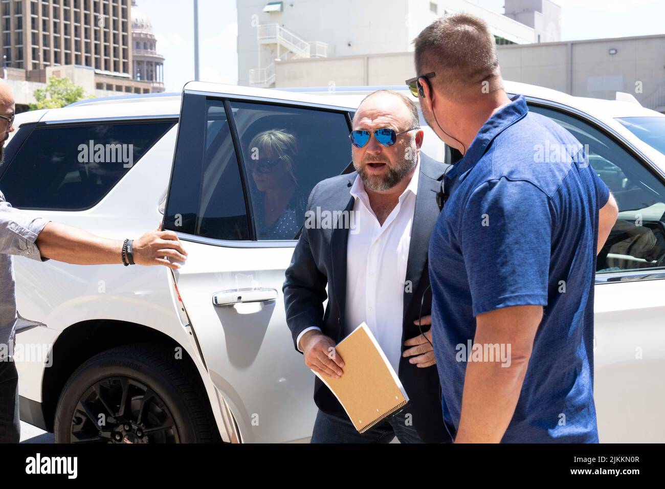 Austin, United States. 02nd Aug, 2022. Austin, United States. 2nd Aug, 2022. Flanked by several bodyguards, InfoWars head ALEX JONES arrives at the Travis County Courthouse for afternoon testimony in his defamation trial in Day 6 on August 2, 2022. Jones has been found guilty for defaming families in the 2012 Sandy Hook school massacre. The jury is to decide whether to award up to $150 million to Sandy Hook families. Credit: Bob Daemmrich/Alamy Live News Stock Photo