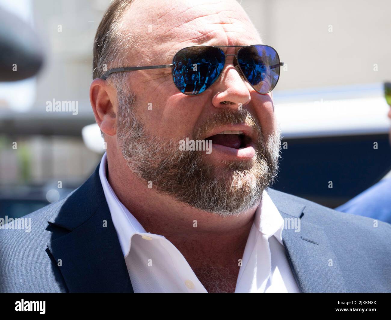 Austin, United States. 02nd Aug, 2022: Flanked by several bodyguards, InfoWars head ALEX JONES arrives at the Travis County Courthouse for afternoon testimony in his defamation trial in Day 6 on August 2, 2022. Jones has been found guilty for defaming families in the 2012 Sandy Hook school massacre. The jury is to decide whether to award up to $150 million to Sandy Hook families. Credit: Bob Daemmrich/Alamy Live News Stock Photo
