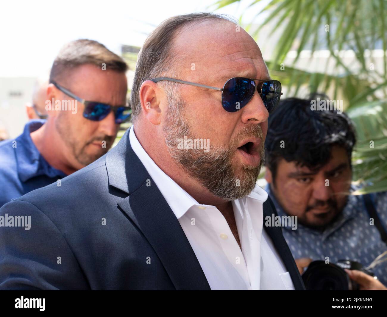 Austin, United States. 02nd Aug, 2022. Austin, United States. 2nd Aug, 2022. Flanked by several bodyguards, InfoWars head ALEX JONES arrives at the Travis County Courthouse for afternoon testimony in his defamation trial in Day 6 on August 2, 2022. Jones has been found guilty for defaming families in the 2012 Sandy Hook school massacre. The jury is to decide whether to award up to $150 million to Sandy Hook families. Credit: Bob Daemmrich/Alamy Live News Stock Photo