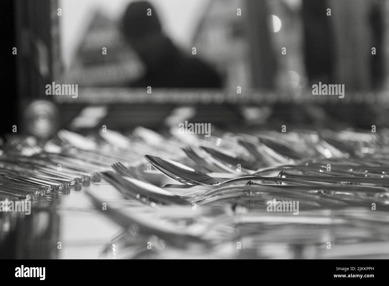 Silver spoons and forks on a blurred background in the buffet Stock Photo