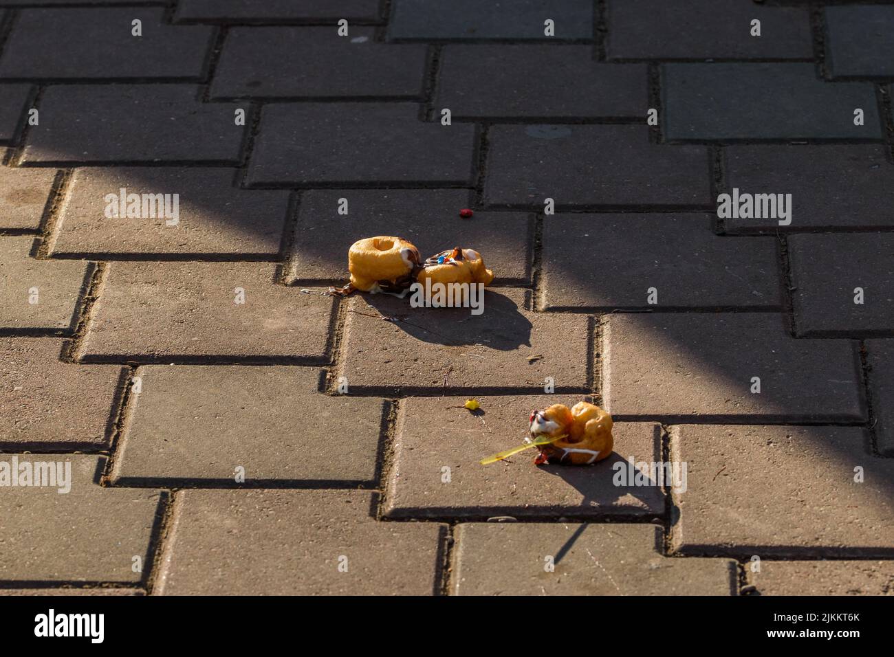 The yummy donuts fallen on the ground tiles Stock Photo