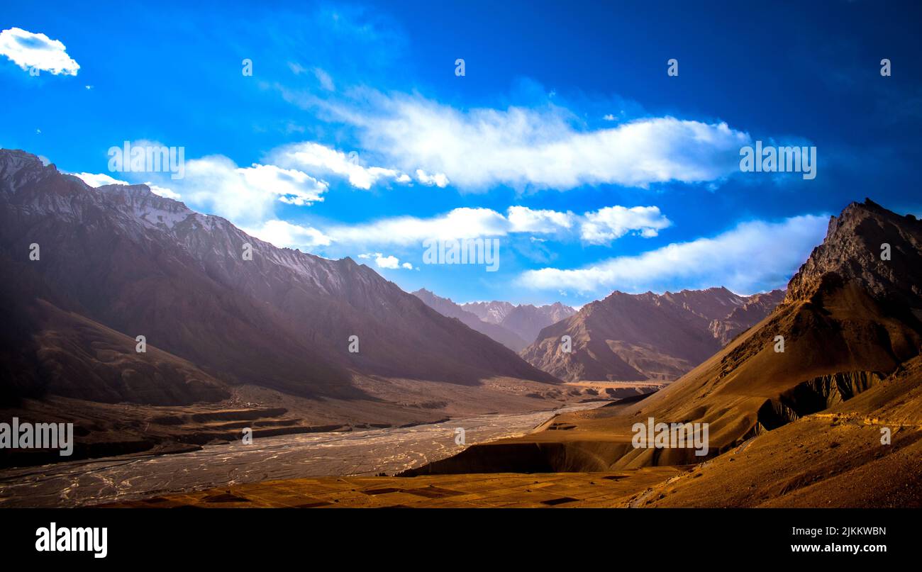 A beautiful view of a valley with mountains under a cloudy sky Stock Photo