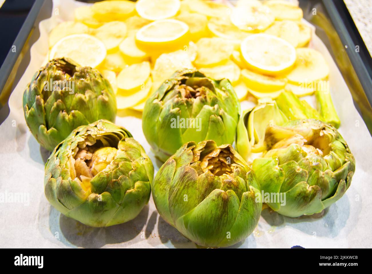Artichoke and potatoes for cooking in a oven Stock Photo Alamy