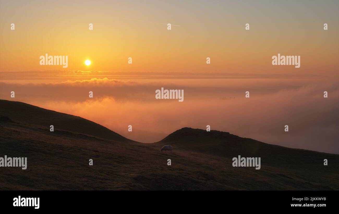 A mesmerizing scene of the rising sun over an inversion near Cardington Moor, Shropshire, UK Stock Photo