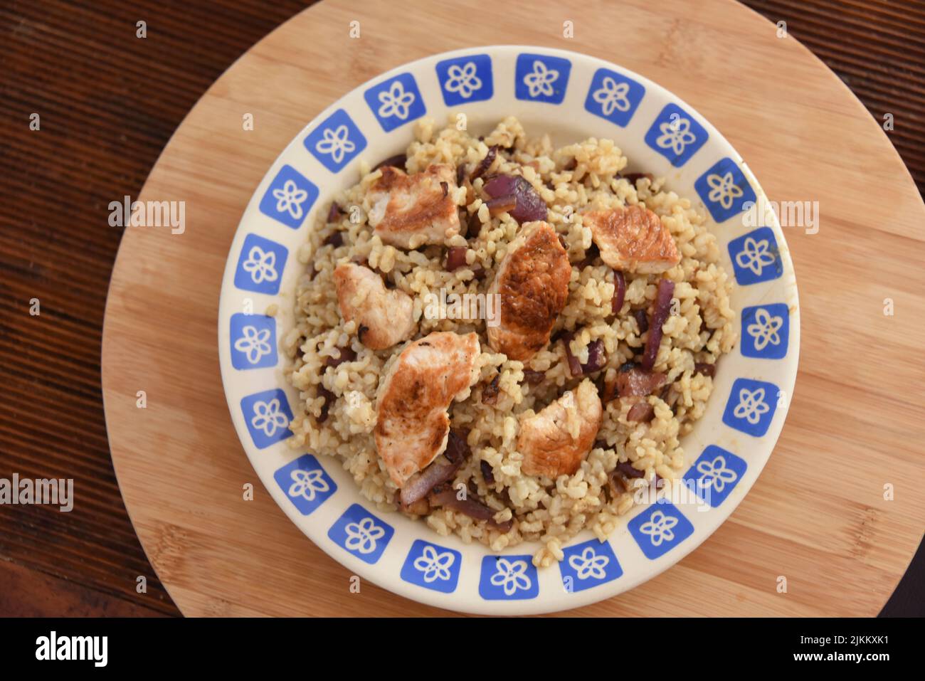 A rice dish on a plate in white background Stock Photo - Alamy